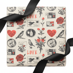 Vintage romance wrapping paper with red roses, hearts, birds, and "LOVE" text, tied with a black satin ribbon on a white background.