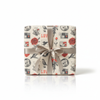 Vintage-style "LOVE" wrapping paper featuring red roses, birds, and postage stamps, tied with an elegant champagne satin ribbon, perfect for anniversaries or Valentine's Day gifts.