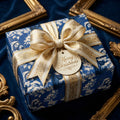 Vintage blue religious Christmas wrapping paper with gold bow and tag by Wrapped Studios.