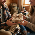 Couple exchanging a gift in rustic vintage map wrapping paper with a burlap bow by Wrapped Studios.