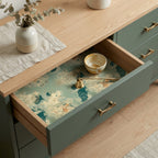 Vintage world map wrapping paper used as drawer liner in a sage green dresser drawer. Wrapped Studios.