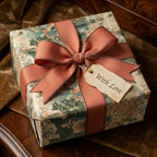 Vintage map wrapping paper on a luxury gift with a dusty rose bow by Wrapped Studios.