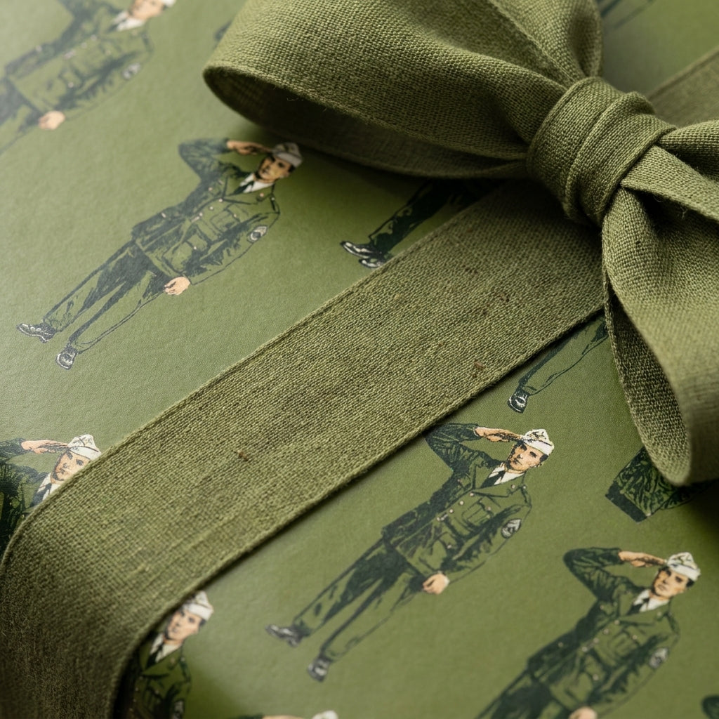 Army military wrapping paper featuring saluting soldiers and olive green linen bow by Wrapped Studios.