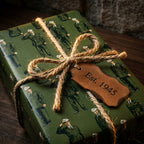 Vintage army soldier wrapping paper in green with a rustic twine bow by Wrapped Studios.