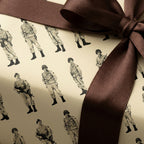 Vintage military soldier wrapping paper tied with a brown satin bow by Wrapped Studios.