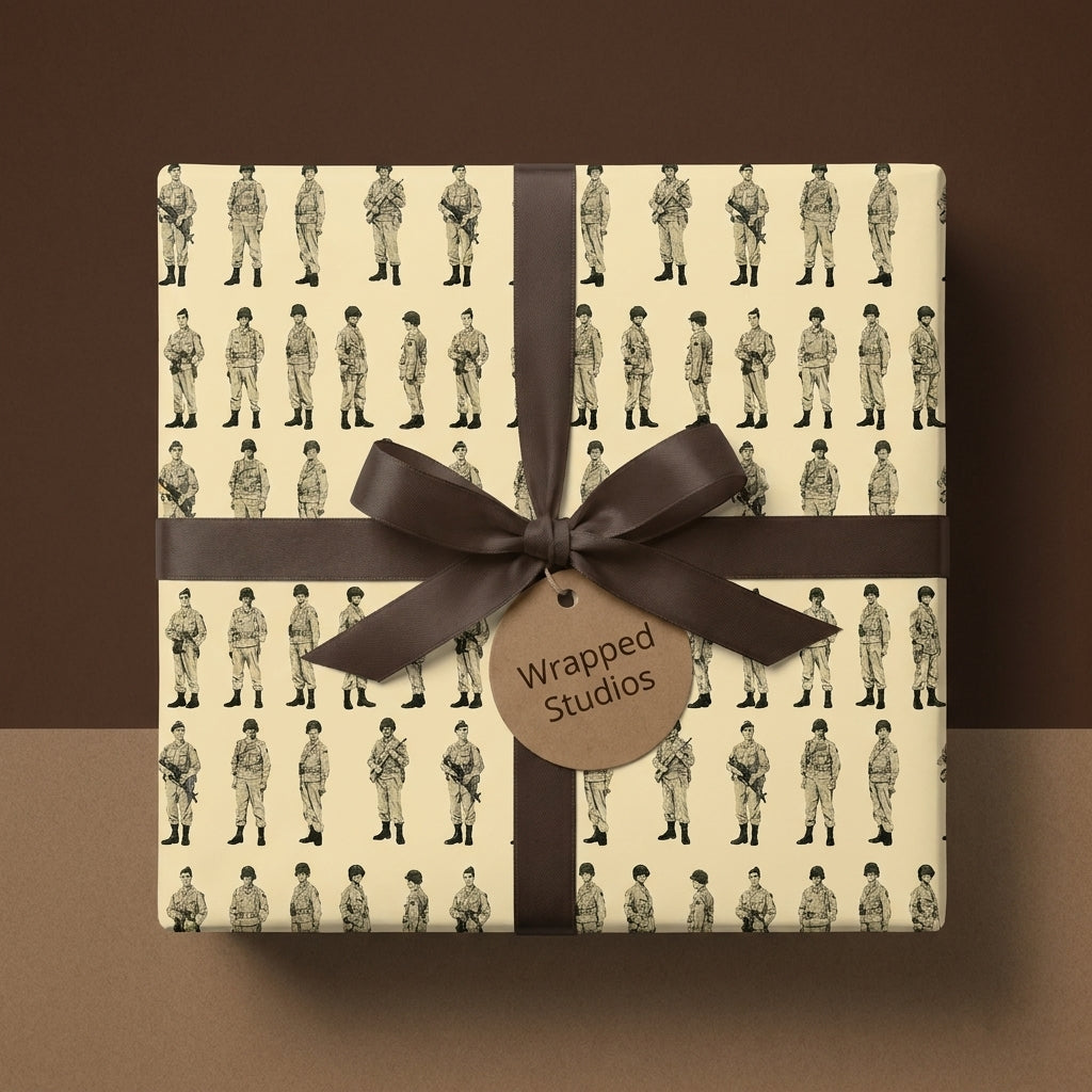 Vintage soldier wrapping paper with military sketches and a brown bow from Wrapped Studios.