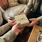 Military soldier wrapping paper by Wrapped Studios on a gift box being passed to a veteran.