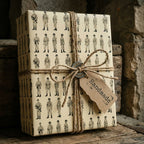 Vintage military wrapping paper on a gift box tied with rustic twine by Wrapped Studios.