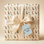 Retro-style gift wrap with dancing women pattern, ivory ribbon, and "For You, Doll" tag.