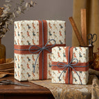 Two gifts wrapped in vintage-style "dancing ladies" wrapping paper with russet ribbon and blue string bows.