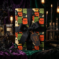Retro monster Halloween wrapping paper with a black bow and gift tag by Wrapped Studios.