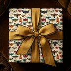 Square gift wrapped in novelty insect wrapping paper with a large mustard bow.