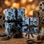 Blue movie themed wrapping paper with vintage camera print and black bows by Wrapped Studios.