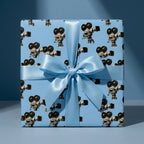 Retro cinema wrapping paper with vintage film cameras and a blue satin bow by Wrapped Studios.