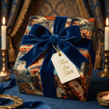 Elegant gift wrapped in vintage Hollywood print paper, tied with a velvet blue ribbon and "For the Star" tag.
