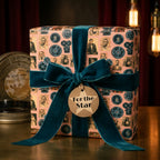 Vintage movie wrapping paper with a teal velvet bow and "For the Star" tag by Wrapped Studios.