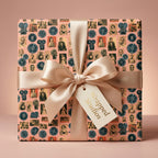 Retro movie gift wrap by Wrapped Studios featuring vintage Hollywood print and a satin bow.