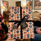 Retro movie wrapping paper with black velvet ribbon and "Enjoy the Show" tag by Wrapped Studios.