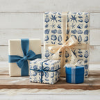 Gifts wrapped in elegant nautical wrapping paper with a blue seashell pattern and coordinating ribbons.