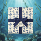 Elegant gift wrapped in nautical themed wrapping paper with dark blue ribbon and bow, against an underwater scene.