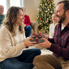 Couple exchanging holiday gift wrapped in luxury Christmas wrapping paper by Wrapped Studios.