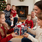 Kids exchanging a gift in blue owl Christmas wrapping paper with a red bow, by Wrapped Studios.