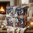 Navy owl Christmas wrapping paper by Wrapped Studios on a gift box with a silver ribbon by a cozy fireplace.