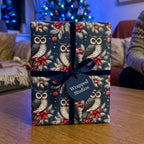Luxury owl Christmas wrapping paper by Wrapped Studios, tied with a blue velvet ribbon.