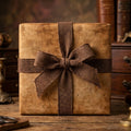 Rustic vintage wrapping paper with a brown burlap bow on a gift box by Wrapped Studios.