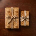 Rustic vintage wrapping paper on gift boxes with burlap bows, by Wrapped Studios.