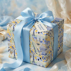 Paris themed luxury gift wrap in blue and yellow with a satin bow on a gift box, by Wrapped Studios.