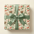 Parisian vintage gift wrap with Eiffel Tower and macarons by Wrapped Studios, tied with a sage green bow.