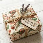 Vintage Paris wrapping paper by Wrapped Studios on a gift box tied with rustic twine and lavender.