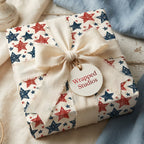 Patriotic star wrapping paper with vintage red and blue stars and a cream linen bow by Wrapped Studios.