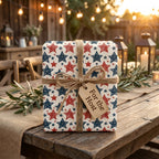 Patriotic wrapping paper with red and blue stars, tied with rustic twine on a wooden table by Wrapped Studios.