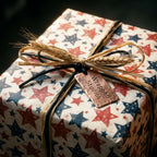 Rustic patriotic wrapping paper with red and blue stars, tied with raffia by Wrapped Studios.