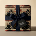 Rustic American flag Christmas wrapping paper with a navy ribbon bow by Wrapped Studios.