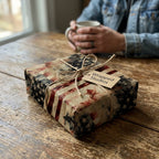Rustic patriotic American flag wrapping paper on a gift with a twine bow by Wrapped Studios.