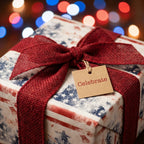 Patriotic 4th of July wrapping paper with red burlap bow and 'Celebrate' tag by Wrapped Studios.