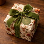 Vintage pheasant wrapping paper with a green velvet bow on a luxury gift box, by Wrapped Studios.