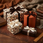 Vintage smoking pipe wrapping paper on cozy gift boxes with velvet bows by Wrapped Studios.