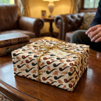 Vintage pipe pattern Father’s Day wrapping paper on a gift box with gold cord, by Wrapped Studios.