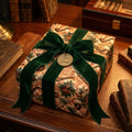 Vintage masculine gift wrap with pipes, a forest green velvet bow, and a "For Dad" tag by Wrapped Studios.
