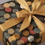 Close-up of gift wrapped in modern polka dot wrapping paper with a gold satin ribbon and bow.