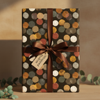 Stylish present wrapped in modern polka dot wrapping paper with brown ribbon.