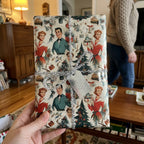 Vintage 1950s retro Christmas wrapping paper by Wrapped Studios, featuring a silver tinsel bow and JOY tag.