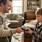 Father giving a boy a birthday gift in outer space wrapping paper by Wrapped Studios.