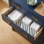 Nautical blue rope wrapping paper used as a drawer liner in a navy dresser, by Wrapped Studios.