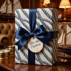 Nautical wrapping paper with blue rope pattern and navy satin bow by Wrapped Studios.