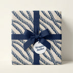 Nautical rope wrapping paper in navy blue and cream with a matching ribbon by Wrapped Studios.